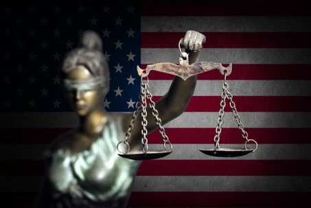 The law symbol with the American flag.